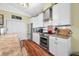 Bright kitchen with white cabinetry, stainless steel appliances, and stone countertops at 8503 Bean Blossom Rd, Trafalgar, IN 46181