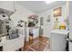 This is a brightly lit laundry room with appliances, a sink, and space for storage at 8503 Bean Blossom Rd, Trafalgar, IN 46181