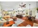 Open-concept living room with hardwood floors, fireplace, kitchen island, and comfortable seating arrangements at 8503 Bean Blossom Rd, Trafalgar, IN 46181