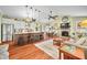 Open-concept living room with a stone fireplace, kitchen, and hardwood floors at 8503 Bean Blossom Rd, Trafalgar, IN 46181