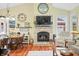Cozy living room with a stone fireplace, TV, and hardwood flooring at 8503 Bean Blossom Rd, Trafalgar, IN 46181
