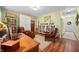 Bright office space with a wooden desk, bookshelves, and comfortable seating, perfect for working from home at 8503 Bean Blossom Rd, Trafalgar, IN 46181