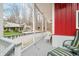 Overlooking the grassy lawn, the porch includes places to sit and is great for relaxing outdoors at 8503 Bean Blossom Rd, Trafalgar, IN 46181