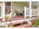 Cozy front porch with seating area and lush greenery, offering a relaxing outdoor space at 8503 Bean Blossom Rd, Trafalgar, IN 46181