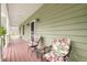 Charming covered porch with comfortable seating, perfect for enjoying the outdoors at 8503 Bean Blossom Rd, Trafalgar, IN 46181