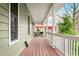 Spacious porch, complete with outdoor seating and open views of the yard and barn at 8503 Bean Blossom Rd, Trafalgar, IN 46181