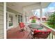 Inviting covered porch featuring outdoor seating, with a view of the surrounding landscape at 8503 Bean Blossom Rd, Trafalgar, IN 46181