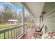 Comfortable seating on the porch provides a relaxing view of the surrounding nature at 8503 Bean Blossom Rd, Trafalgar, IN 46181