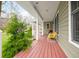 Inviting porch with wooden floors, comfortable seating, and serene views of surrounding greenery and mature trees at 8503 Bean Blossom Rd, Trafalgar, IN 46181