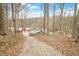 Scenic view of the property showing the house, outbuildings, and wooded area at 8503 Bean Blossom Rd, Trafalgar, IN 46181