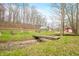 Beautiful property view showcasing the house, outbuildings, bridge and surrounding landscape at 8503 Bean Blossom Rd, Trafalgar, IN 46181