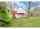 Beautiful outbuilding with a charming porch, spacious garages, and a large grassy lawn at 8503 Bean Blossom Rd, Trafalgar, IN 46181
