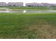 A well-manicured backyard backs up to a retention pond and residential homes at 8801 Twain Ln, Indianapolis, IN 46239
