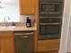 Kitchen boasts stainless steel appliances, oak cabinetry, and tile backsplash at 8801 Twain Ln, Indianapolis, IN 46239