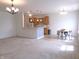 Open-concept living space with kitchen, breakfast bar, hardwood floors, and natural lighting at 8801 Twain Ln, Indianapolis, IN 46239