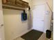 Functional mud room with storage shelves, coat hooks, utility access, and convenient access to the outside at 8801 Twain Ln, Indianapolis, IN 46239
