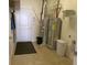 Utility room featuring modern equipment, including a hot water heater and furnace and additional storage at 8801 Twain Ln, Indianapolis, IN 46239