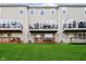 View of backyards with multiple decks, patios, and balconies from the green lawn at 9010 Ramapo Dr, Fishers, IN 46038