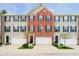 Charming three-story townhome with brick and siding, attached garages, and landscaped front yards at 9010 Ramapo Dr, Fishers, IN 46038