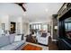 Open-concept living room with hardwood floors, flowing into dining and kitchen areas at 9010 Ramapo Dr, Fishers, IN 46038