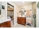 A view from the bathroom into the bedroom of a wooden vanity and glass enclosed shower at 9010 Ramapo Dr, Fishers, IN 46038
