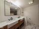 Stylish bathroom features double sink vanity with a large mirror and marble flooring at 905 W 3Rd St, Anderson, IN 46016