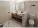 Bathroom featuring a double sink vanity, stylish mirror and a water closet at 905 W 3Rd St, Anderson, IN 46016