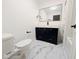 Bathroom featuring a black vanity, stylish mirror, commode and marble flooring at 905 W 3Rd St, Anderson, IN 46016