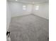 Bedroom featuring neutral carpet, white walls and trim, and two windows at 905 W 3Rd St, Anderson, IN 46016
