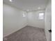 Bedroom featuring neutral carpet, white walls and trim, and two windows at 905 W 3Rd St, Anderson, IN 46016