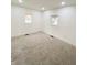 Bright bedroom featuring neutral carpet, white walls and trim, and two windows at 905 W 3Rd St, Anderson, IN 46016