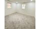 Bedroom featuring neutral carpet, white walls and trim, and two windows at 905 W 3Rd St, Anderson, IN 46016