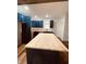 Modern kitchen features butcher block countertops, dark blue cabinets and ample natural light at 905 W 3Rd St, Anderson, IN 46016