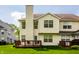 Back exterior shot highlighting the deck and the home's design, complete with a well-kept lawn at 9338 Eden Woods Ct, Indianapolis, IN 46260