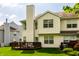 Rear exterior view showcasing a well-maintained lawn, wooden deck, and siding at 9338 Eden Woods Ct, Indianapolis, IN 46260