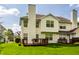 Exterior view of the house, highlighting the back deck, yard, and the home's classic architectural style at 9338 Eden Woods Ct, Indianapolis, IN 46260