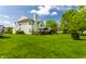 A spacious backyard, complete with a wooden deck, leads up to a classic home exterior at 9338 Eden Woods Ct, Indianapolis, IN 46260
