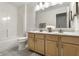 Well-lit bathroom featuring a double sink vanity and shower-tub combo at 9338 Eden Woods Ct, Indianapolis, IN 46260