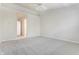 Bright bedroom with plush carpeting and doorway leading to bathroom at 9338 Eden Woods Ct, Indianapolis, IN 46260
