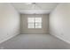 Spacious bedroom with neutral carpet, large window, and ceiling fan at 9338 Eden Woods Ct, Indianapolis, IN 46260