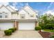 Charming townhome with a two-car garage and well-maintained landscaping at 9338 Eden Woods Ct, Indianapolis, IN 46260