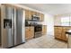 Well-lit kitchen featuring stainless steel appliances and light wood cabinets and black countertops at 9338 Eden Woods Ct, Indianapolis, IN 46260