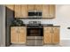 Kitchen with stainless steel appliances, oven, microwave, and light wood cabinetry at 9338 Eden Woods Ct, Indianapolis, IN 46260