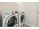 Laundry room with a front loading washer and dryer and wire shelving at 9338 Eden Woods Ct, Indianapolis, IN 46260