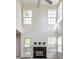Bright living room with a fireplace, plenty of windows, and access to the outdoors at 9338 Eden Woods Ct, Indianapolis, IN 46260