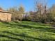 A spacious backyard featuring lush green grass and various trees for a serene outdoor setting at 935 Fry Rd, Greenwood, IN 46142