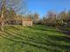 A large backyard with green grass and scattered trees offering a private, natural setting at 935 Fry Rd, Greenwood, IN 46142