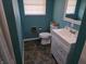 Well-lit bathroom with a modern vanity, toilet, stylish mirror and blue walls at 935 Fry Rd, Greenwood, IN 46142