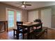Well-lit dining room with a ceiling fan, table with bench seating, and direct access to the porch at 935 Fry Rd, Greenwood, IN 46142