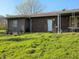 View of the exterior with brick and wooden siding, a covered porch, and a green lawn at 935 Fry Rd, Greenwood, IN 46142